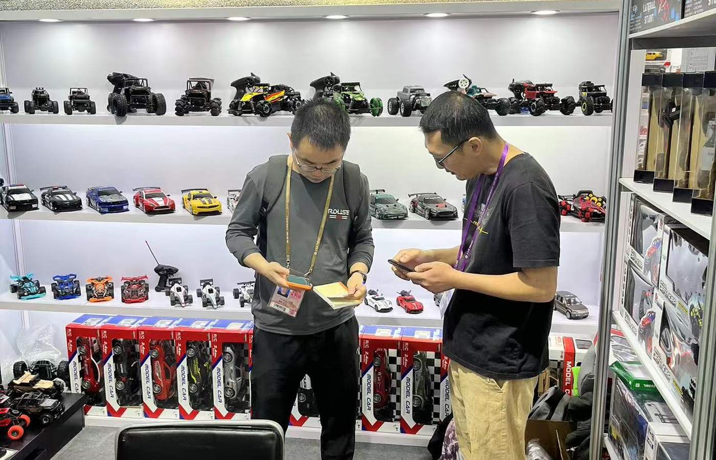Buyers reviewing the toy product wall at the Canton Fair booth