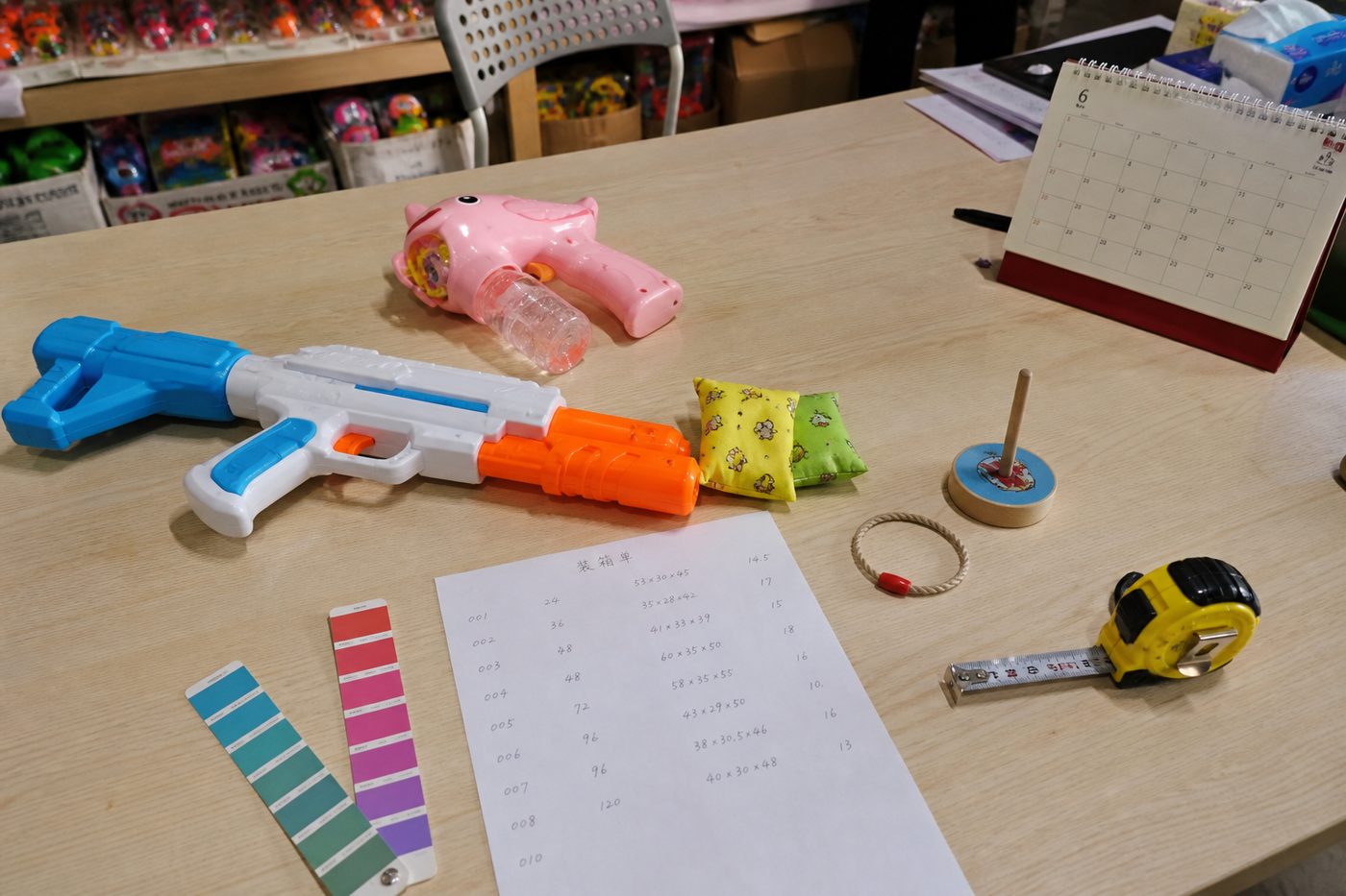 Toy samples and packing notes on a range-planning table